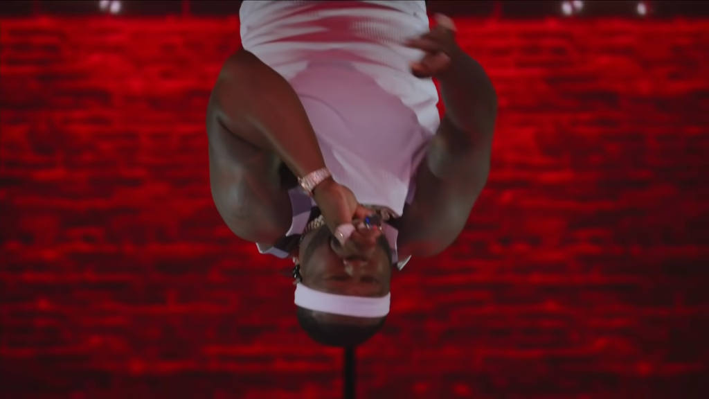 An inverted, upside-down portrait of rapper 50 Cent looking directly at the viewer.