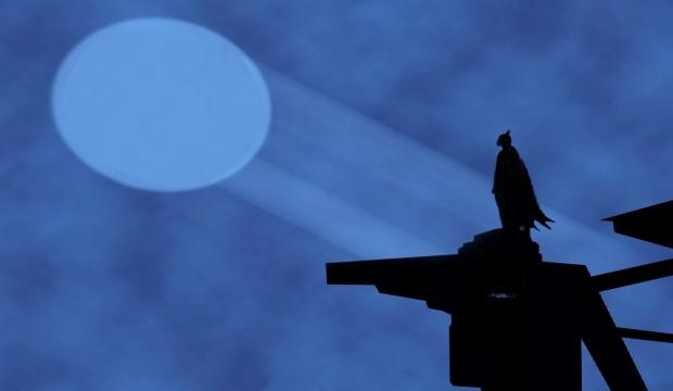 Batman Bat-Signal projected in Gotham night sky - iconic beacon meme template