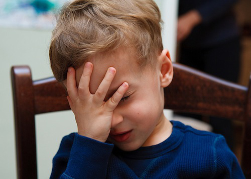 A character looking visibly embarrassed, uncomfortable, or caught in an awkward situation.